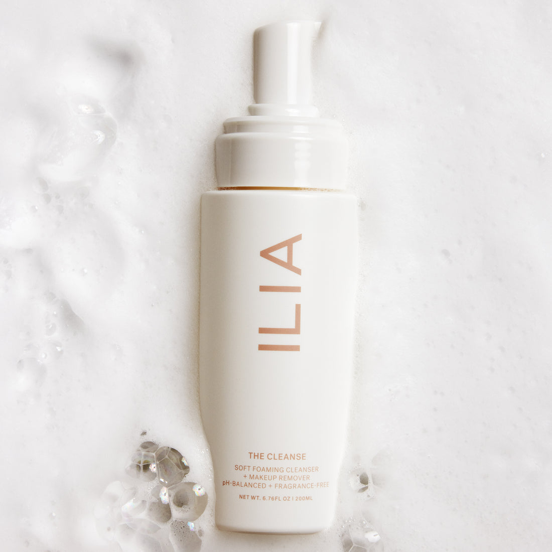 ILIA's the Cleanse in a puddle of foamy cleanser water.