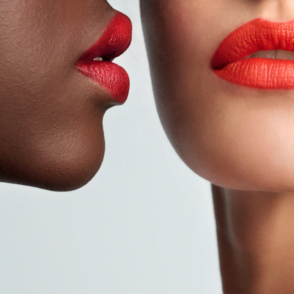 Two bright red shades of Lip Sketch applied to two models lips on a light background.