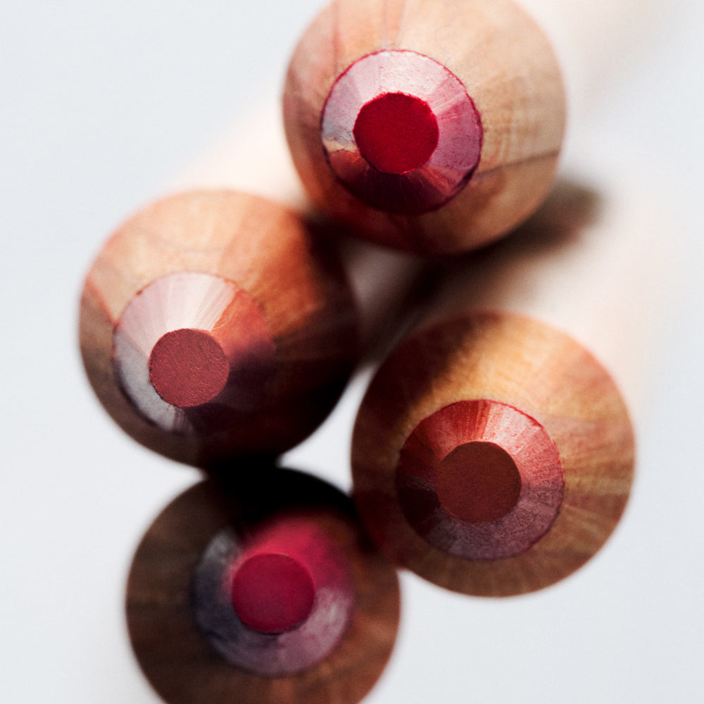 An above perspective of four wooden Lip Sketch shades standing up on a light background.