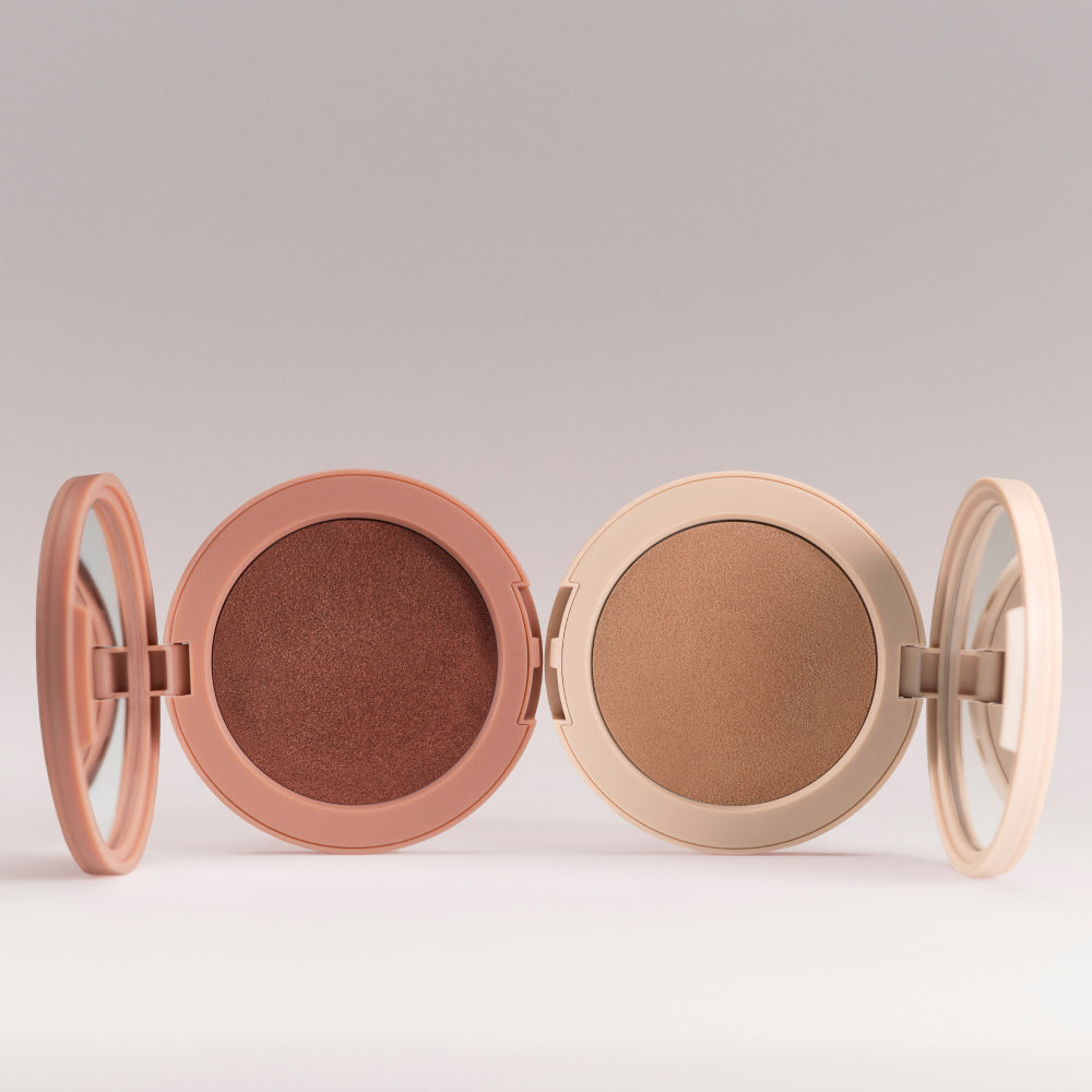 Sunshift Cream Bronzer and Lightshift Cream Highligher components laid next to one other on a grey background.