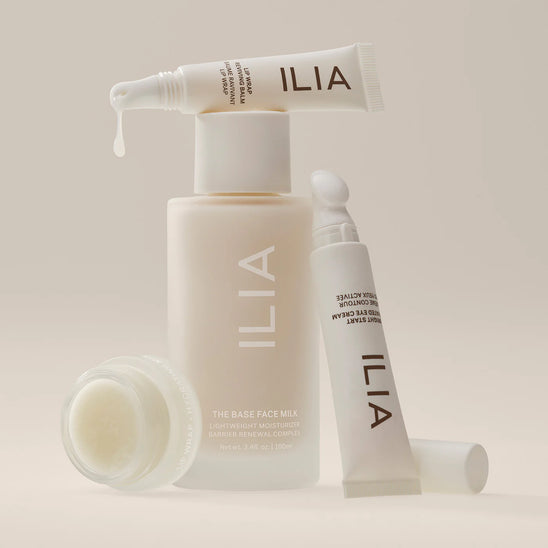 An assortment of ILIA Skincare including Face Milk, Eye Cream, and two lip products.
