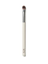 A close up of ILIA Shadow Brush that has a flat, tapered head and a white handle.